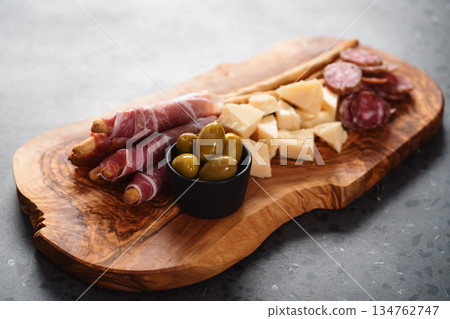 Italian snacks on olive wood board 134762747