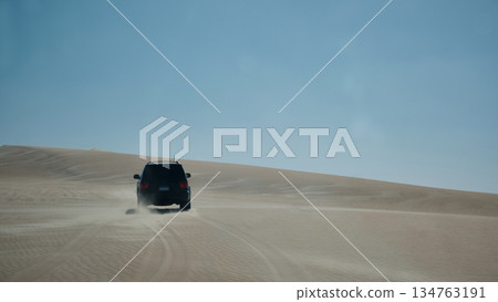 Off-Road Vehicle Driving Across Desert Dunes Off-Road Vehicle Driving Across Desert Dunes 134763191