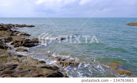 Rocky Coastline Meeting the Calm Blue Sea 134763663