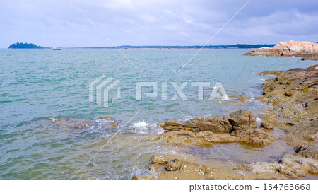 Panoramic View of Tropical Bay with Distant Island Panoramic View of Tropical Bay with Distant Island 134763668