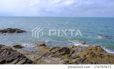 Serene Coastal Landscape with Rocks and Open Sea 134763671