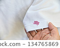 dirty pink cosmetic stain on white shirt in daily life. stain for cleaning concept. 134765869
