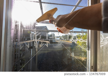A worker using a dew eliminator wiper to remove water droplets A worker using a dew eliminator wiper to remove water droplets 134767009