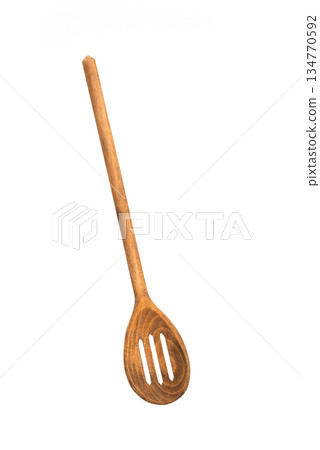 Wooden slotted spoon isolated on white background, natural kitchen utensil for cooking, serving, and food preparation. Wooden slotted spoon isolated on white background, natural kitchen utensil for cooking, serving, and food preparation. 134770592