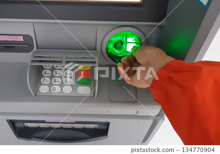 ATM for receiving funds. Hands of a man at an ATM. ATM for receiving funds. Hands of a man at an ATM. 134770904
