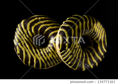 Two American donuts covered with shekolade on a black background 134771161