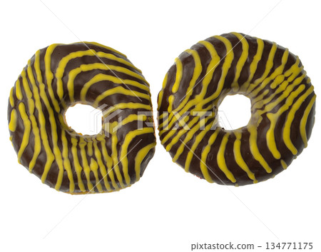 Two American donuts covered with chocolate and with yellow stripes on a white background 134771175
