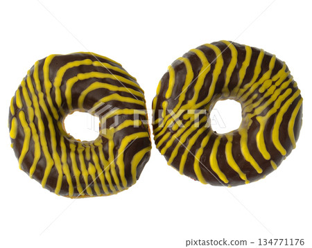 Two American donuts covered with chocolate and with yellow stripes on a white background Two American donuts covered with chocolate and with yellow stripes on a white background 134771176