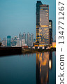 big city skyline at sunset with mirrored water reflection, modern high-rise skyscrapers at golden hour urban dusk, downtown mirroring on swimming pool, Bangkok Thailand 134771267