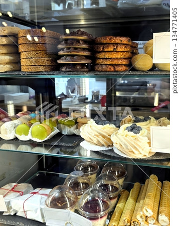 Pastries and Sweets Displayed in an Inviting Cafe Setting During a Busy Morning 134771405