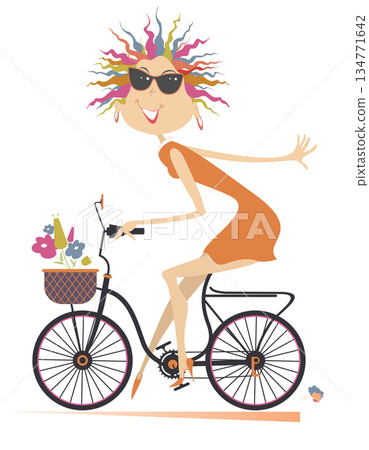 Pretty young cycling woman with bouquets of flowers in the basket. Cycling woman carries bouquets of flowers in the basket	 134771642