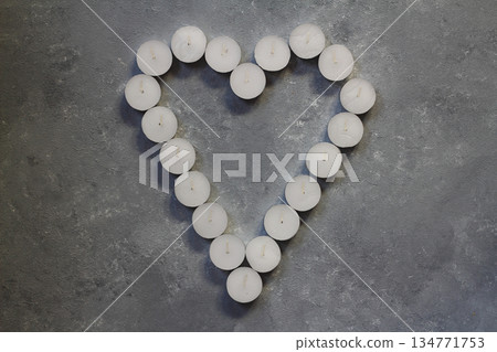 White candles in the shape of heart on stone background, concept of Valentine's Day 134771753
