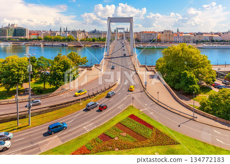 Elisabeth Bridge over the Danube River with historic buildings of Pest city center, sunny day aerial view, Budapest, Hungary Elisabeth Bridge over the Danube River with historic buildings of Pest city center, sunny day aerial view, Budapest, Hungary 134772183