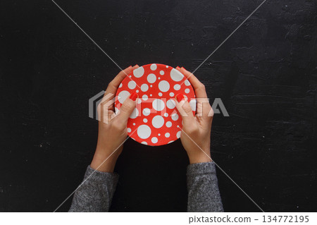 Woman hands give valentine or other holiday handmade present in paper with red ribbon Woman hands give valentine or other holiday handmade present in paper with red ribbon 134772195