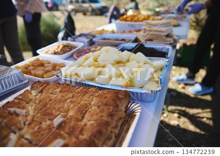 Outdoor Buffet With Fresh Fruit And Baked Goods At A Community Gathering 134772239