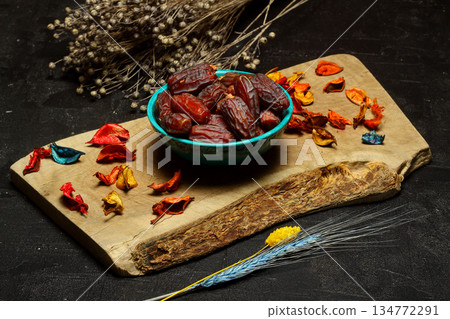 Dried dates on a wooden table in silver dishes close-up. Composition of dried dates in ramadan dish 134772291