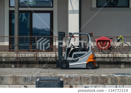 Forklift parked on harbor quay Venice, Italy 134772319