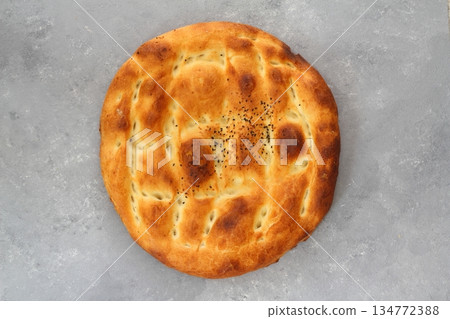 Slices of Ramadan Pita (Ramazan Pidesi) Traditional Turkish bread for holy month Ramadan on black background Slices of Ramadan Pita (Ramazan Pidesi) Traditional Turkish bread for holy month Ramadan on black background 134772388