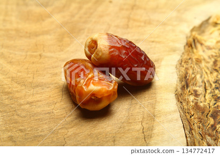Dates on a stone background. Dried fruits. Dried dates lie next to each other 134772417