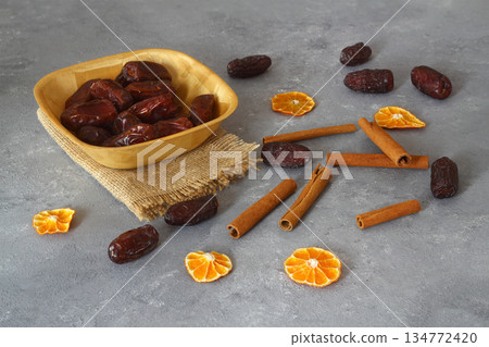 Dried dates on a wooden table in silver dishes close-up. Composition of dried dates in ramadan dish 134772420