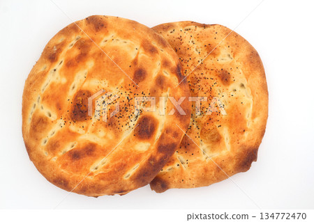 Slices of Ramadan Pita (Ramazan Pidesi) Traditional Turkish bread for holy month Ramadan on white background Slices of Ramadan Pita (Ramazan Pidesi) Traditional Turkish bread for holy month Ramadan on white background 134772470