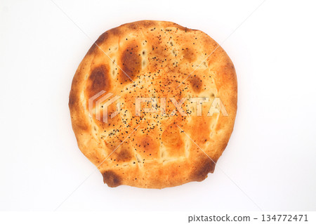 Slices of Ramadan Pita (Ramazan Pidesi) Traditional Turkish bread for holy month Ramadan on white background 134772471