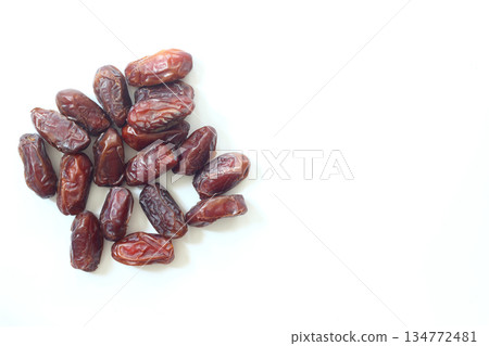 Dates on a white background. Dried fruits. Dried dates lie next to each other 134772481