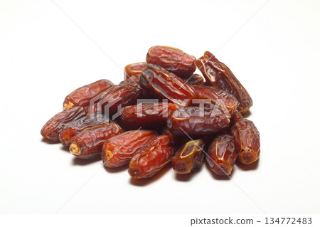 Dates on a white background. Dried fruits. Dried dates lie next to each other 134772483