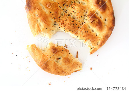Slices of Ramadan Pita (Ramazan Pidesi) Traditional Turkish bread for holy month Ramadan on white background 134772484