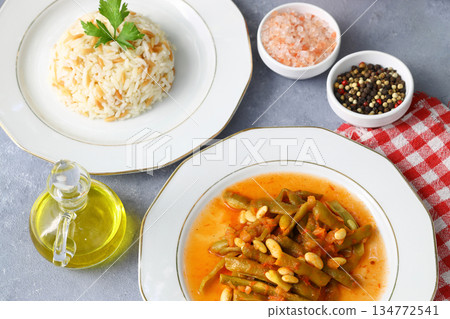 Homemade stewed green beans, tomatoes, garlic with olive oil. Zeytinyagli fasulye traditional food Homemade stewed green beans, tomatoes, garlic with olive oil. Zeytinyagli fasulye traditional food 134772541