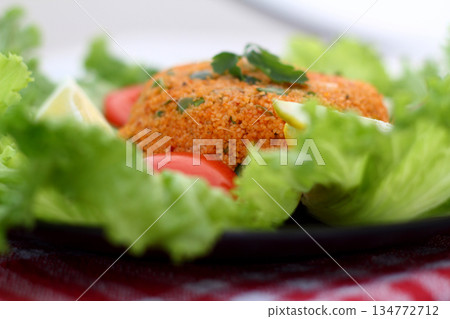 Traditional Turkish bulgur salad Kisir close-up on a plate on the table. Horizontal view from above Traditional Turkish bulgur salad Kisir close-up on a plate on the table. Horizontal view from above 134772712