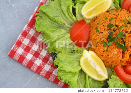 Traditional Turkish bulgur salad Kisir close-up on a plate on the table. Horizontal view from above 134772713