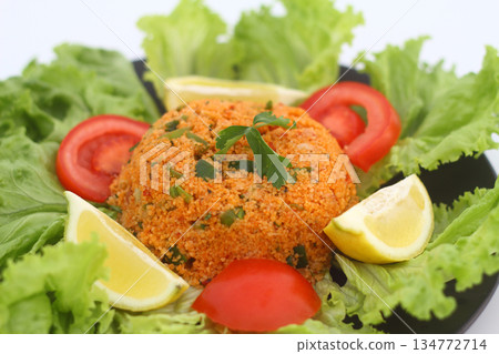 Traditional Turkish bulgur salad Kisir close-up on a plate on the table. Horizontal view from above Traditional Turkish bulgur salad Kisir close-up on a plate on the table. Horizontal view from above 134772714