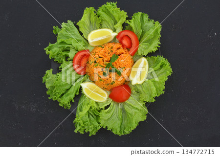 Traditional Turkish bulgur salad Kisir close-up on a plate on the table. Horizontal view from above 134772715