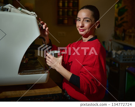 Cafe Owner Crafting Coffee Behind Espresso Machine in Cozy Caf? Kitchen 134772724