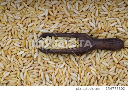 Raw fresh and healthy dry organic barley noodle on wooden spoon Raw fresh and healthy dry organic barley noodle on wooden spoon 134772802