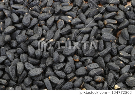 Black cumin seeds background. Nigella sativa. Top view. close up black cumin. 134772803