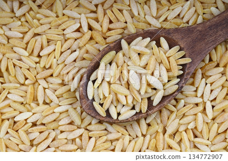 Raw fresh and healthy dry organic barley noodle on wooden spoon Raw fresh and healthy dry organic barley noodle on wooden spoon 134772907