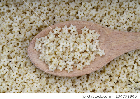 Raw Organic Stelline Pasta in a Bowl, top view. Flat lay, overhead, from above. Macaroni stars. Star shaped noodles. Raw Organic Stelline Pasta in a Bowl, top view. Flat lay, overhead, from above. Macaroni stars. Star shaped noodles. 134772909