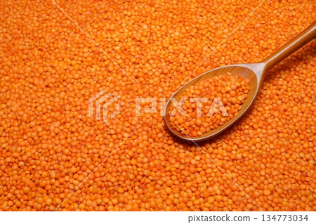 Red lentils scattered close-up with a spoon. Red lentils scattered close-up with a spoon. 134773034