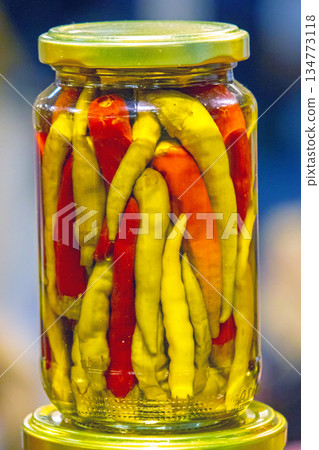 Colorful pickled chili peppers in glass jar Colorful pickled chili peppers in glass jar 134773118