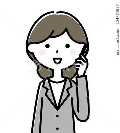 A woman in a suit talking on a smartphone 134773657
