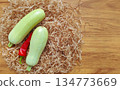 Fresh zucchini and chili peppers on a wooden background. Top view with space for text. 134773669