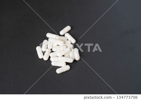 calcium supplement in the form of white capsules on a neutral background calcium supplement in the form of white capsules on a neutral background 134773706