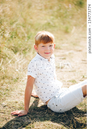 Outdoor family moment with mother and sons in a sunny field for campaigns and storytelling 134773774