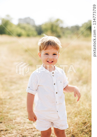 Joyful child outdoors, capturing everyday family moments and the warmth of love, togetherness, and childhood happiness Joyful child outdoors, capturing everyday family moments and the warmth of love, togetherness, and childhood happiness 134773789