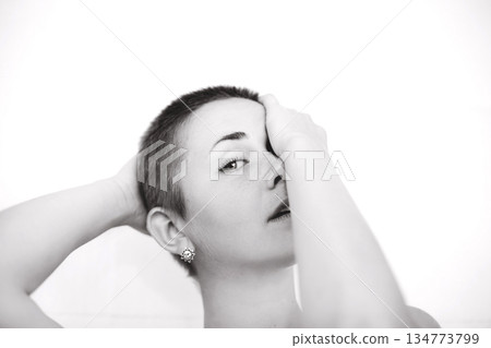 Young woman with short hair expressing vulnerability and emotion Young woman with short hair expressing vulnerability and emotion 134773799