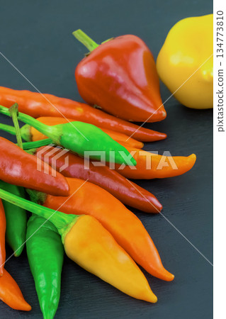 chili pepper red, yellow asia seasoning on black background chili pepper red, yellow asia seasoning on black background 134773810