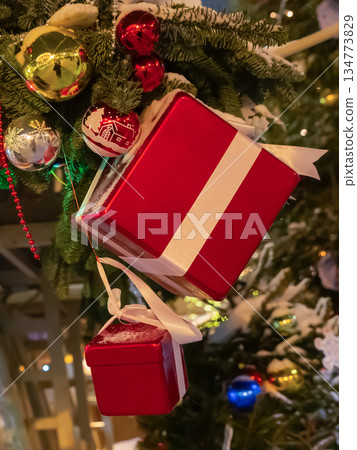 Christmas background with gift boxes and decorations on the tree Christmas background with gift boxes and decorations on the tree 134773829