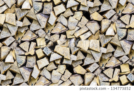stacked lots of wooden logs for a fireplace or stove 134773852